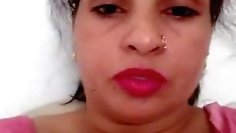 Busty brunette masturbates on bed with a huge sex toy