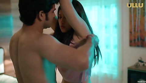 A brunette girl in a red dress is doing sexy moves