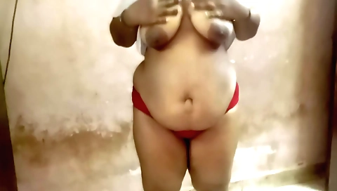 Busty indian lady with a big ass is having tea in her home