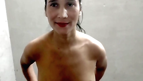 Girl with a small body is taking a shower in the room